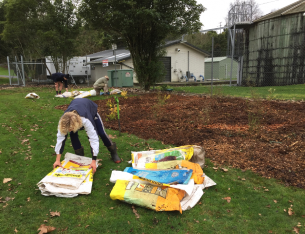 Tidying empty mulch bags. Cambridge Tree Trust.